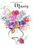 This Mother's Day card presents a vibrant, whimsical bouquet painted in flowing watercolour, capturing the gentle elegance of Marylebone with an artist's touch. At the bottom of the composition sits a small, rounded vase, delicately suggested rather than heavily outlined, and finished with a graceful golden bow that ties the scene together. From this base springs a generous spray of flowers, each bloom rendered in loose, gestural strokes. Intense cerise, bright fuchsia, and velvety magenta blossoms form the focal point, their edges brushed with deep indigo and midnight blue that add definition and depth. Around them, lighter flowers in lavender, soft blue, and powdery lilac create airy spaces, while subtle splashes of apricot and blush lend warmth, like the glow of evening light along Marylebone High Street. Fine lines and dashes of metallic gold flicker across petals and leaves, giving the impression of scattered sunlight. The white background is alive with playful splatters and tiny hearts in coordinating hues, drifting around the bouquet like confetti or the joyful scatter of petals after arranging a hand-tied gift. The illustration feels both spontaneous and thoughtfully composed, much like the work of an experienced local florist who knows exactly how to express emotion through colour and form. There is a sense of uplift and tenderness in the way the bouquet seems to lean outward, as if offering itself to the viewer. Ideal for Mother's Day, this card pairs beautifully with fresh floral deliveries throughout Marylebone, from the cobbled side streets near Baker Street to the elegant terraces edging Regent's Park.